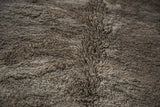 Textured silver grey natural wool pile showing abrash on a vintage Moroccan rug.
