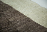 Rug pile showing diagonal transition of ivory and silver grey natural wool.