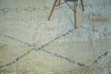 Plush ivory pile with minimalistic blanched charcoal outlines on a vintage Moroccan rug.