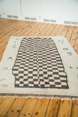 Hand-knotted vintage Moroccan carpet with playful brown and cream checkered pattern and fringe.