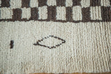 Vintage Moroccan carpet with a shaggy pile, dark brown checkered pattern and abstract motifs.