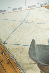 Shaggy pale ivory pile with chalk-sky blue lines on a vintage Moroccan carpet.