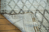 Woven foundation of a vintage Moroccan carpet, showing plush ivory and charcoal pile.