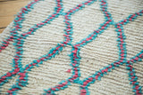 Thick ivory pile with unusual hot pink and aqua blue lattice motif.