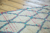 Shaggy ivory vintage Moroccan rug pile, with a geometric hot pink and aqua blue lattice.
