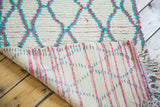 Vintage Moroccan runner's hand-knotted back weave and textured hot pink aqua pile.