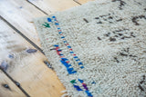 Textured wool pile of a Vintage Moroccan rug, showing playful colorful patterns.