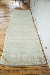 Long Moroccan runner rug showcasing platinum ivory shaggy pile texture, 3x10 feet.