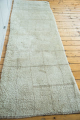 Plush, platinum ivory pile of a modern Moroccan runner rug with subtle linear texture.