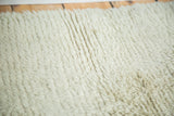 High, shaggy platinum ivory pile texture on the Moroccan rug.