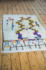 Textured pile showing stepped checker pattern and colorful pictorial figures.