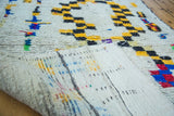 Vintage Moroccan rug showcasing its thick pile and vibrant, multicolor woven foundation.
