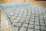 Dense ivory pile with a charcoal geometric lattice pattern on a vintage Moroccan rug.