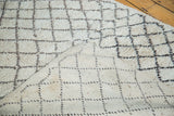Vintage Moroccan rug showing thick ivory pile and reverse charcoal lattice weave.