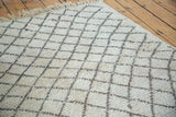 Hand-knotted vintage Moroccan rug featuring shaggy ivory pile and minimalist charcoal lattice.