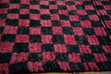 Shaggy red and charcoal checkerboard squares on vintage Moroccan rug.