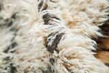 Vintage Beni Ourain Moroccan rug's fluffy ivory pile and charcoal outlines.