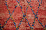 Vintage Moroccan rug showing deep cherry red abrashes and blue saffron lattice.