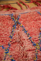 Moroccan rug's textured cherry red pile with subtle abrashes, blue, and saffron lattice.