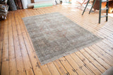 Vintage Oushak rug with distressed peach, ivory, and beige geometric border.