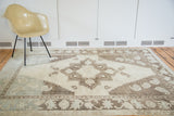 Vintage Oushak carpet displaying whimsical center medallion and distinct pale mint, silver abrashes.