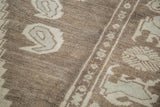 Close-up of vintage Oushak rug pile with blanched ivory whimsical geometric motifs.
