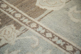 Whimsical geometric motif and abrashes on a Vintage Oushak rug in pale mint and ivory.