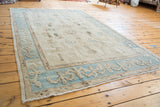 Vintage Oushak rug corner showing pale aqua blue border and reciprocating motif.