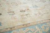 Pale aqua blue border with reciprocating motif on platinum ivory field of vintage Oushak.