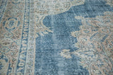 Textural detail of the distressed Oushak rug with sky blue field and blanched ivory patterns.