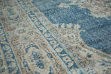 Distressed Oushak carpet with blanched ivory border patterns and faded sky blue field.
