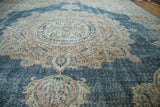 Distressed Oushak carpet texture, featuring faded sky blue and blanched ivory patterns.