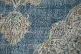 Distressed pile texture of sky blue Oushak carpet, blanched ivory floral design.