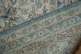 Distressed Oushak carpet pile in muted tones, revealing its tight hand-knotted geometric reverse.