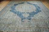 Distressed Oushak carpet highlighting its worn texture, faded sky blue, and ivory hues.