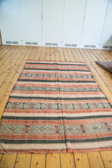 Vintage Jijim carpet's textured weave showing wine red, platinum, and charcoal geometric stripes.