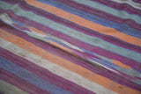 Textured tribal geometric stripes on vintage Moroccan kilim in orange, purple, gray, ivory, bronze.
