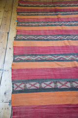 Intricate serrated geometric patterns on a charcoal stripe of the vintage kilim rug runner.