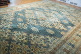 Intricate geometric patterns in aqua teal, beige, and bronze on Oushak rug.