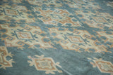 Intricate geometric patterns in sun-kissed aqua teal and beige on a vintage Oushak carpet.