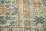Geometric design in sun-kissed aqua teal, beige, and bronze on vintage Oushak carpet.