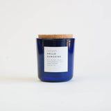 Hello Sunshine Soy Candle in a sapphire blue glass jar with a cork lid, 8 oz.