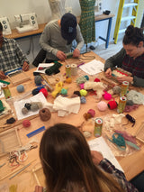 Katonah NY weaving workshop participants crafting textiles with colorful yarns and looms.