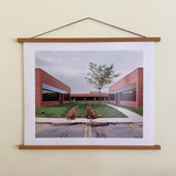 The Schoolyard color photograph by Joe Farrell hangs in a natural wood poster frame.