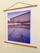 Joe Farrell's color photograph 'Empty Pool' displayed in a hanging wooden poster frame.