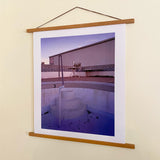 Joe Farrell's Empty Pool photograph displayed in a wooden poster hanger against a neutral wall.