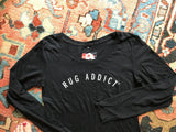 Overhead view of the black long sleeve t-shirt with its white arched 