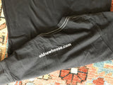 Sleeve of the charcoal t-shirt showing the white contrast stitch and oldnewhouse.com print.