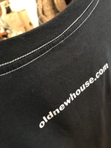 White URL printed below the contrast stitching on a men's charcoal t-shirt.
