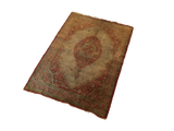 Angled view of an antique silk Tabriz rug mat highlighting its traditional medallion and borders.